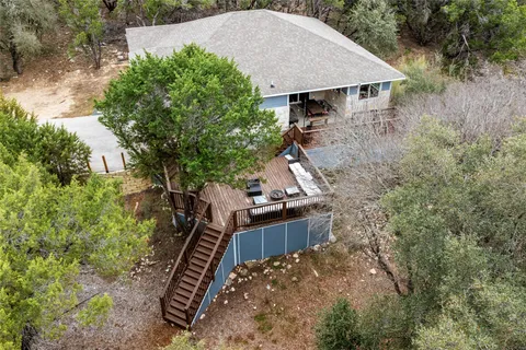 an aerial view of a house with a yard