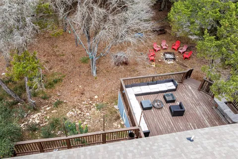 a view of a balcony with wooden floor and a potted plant