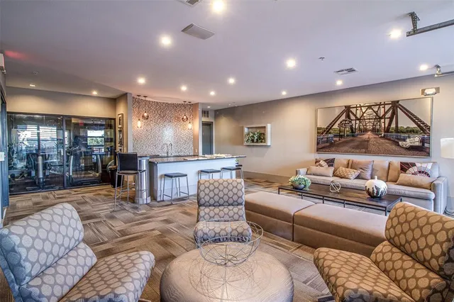 a living room with furniture and a glass door