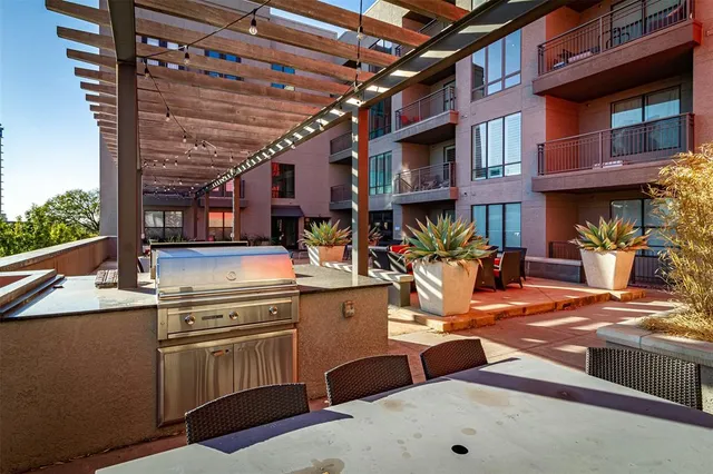 a view of a patio with a table and chairs
