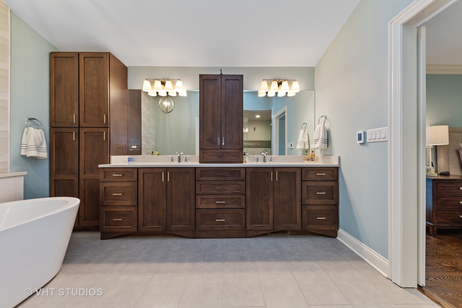 2801 Meyers Road Oak Brook, IL 60523 - Photo 22 of 48 a bathroom with a tub a double vanity sink and a large mirror