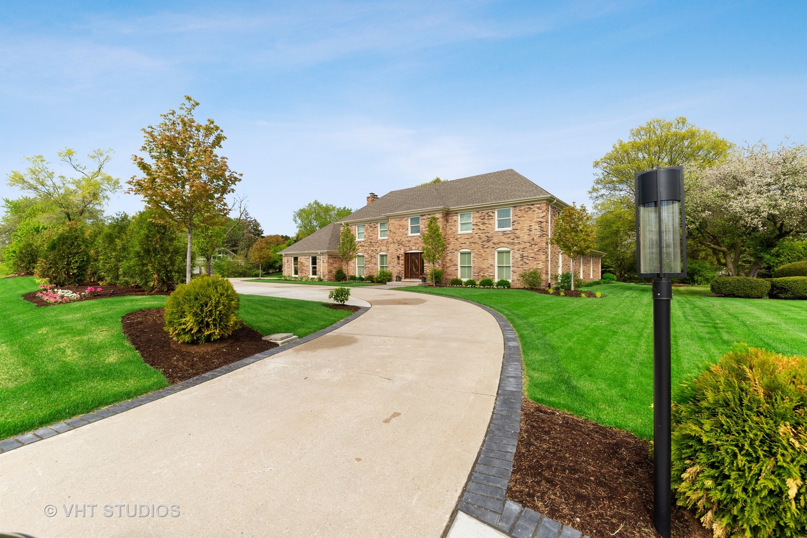 2801 Meyers Road Oak Brook, IL 60523 - Photo 43 of 48 a front view of a house with a yard and potted plants