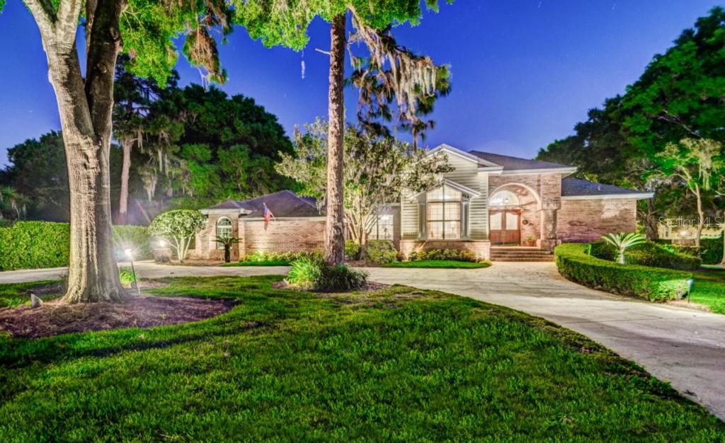 959 Riverside Ridge Road Tarpon Springs, FL 34688 - Photo 1 of 1 a front view of a house with a yard and potted plants
