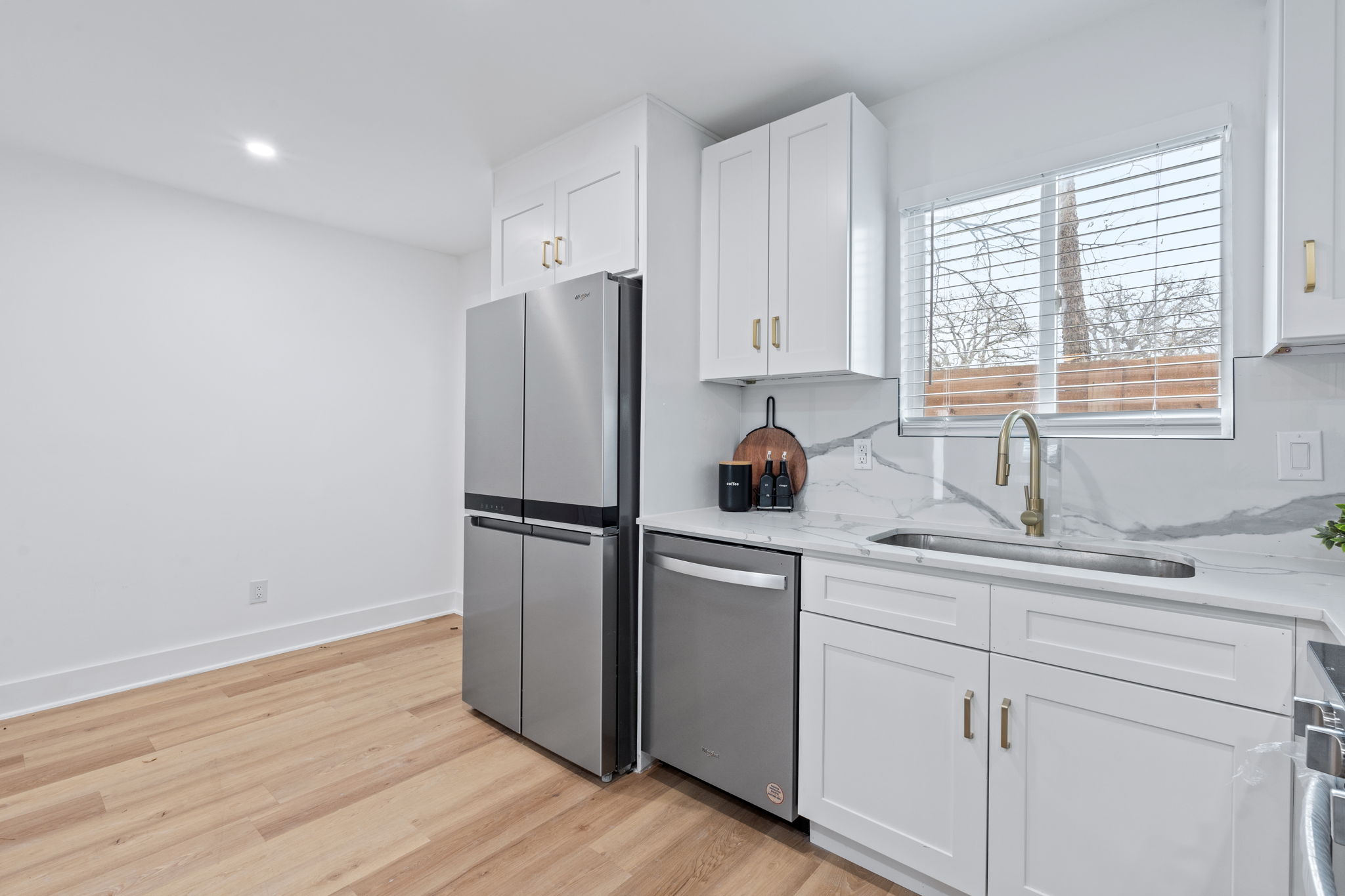 2706 Wheless Lane, Unit 101 Austin, TX 78723 - Photo 12 of 24 a kitchen with a refrigerator sink and cabinets