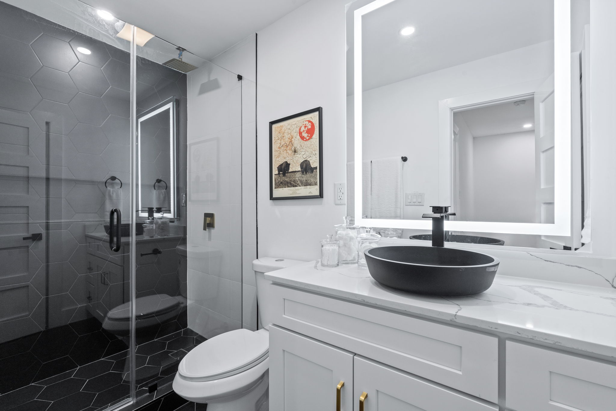 2706 Wheless Lane, Unit 101 Austin, TX 78723 - Photo 16 of 24 a bathroom with a granite countertop sink a toilet a shower and a mirror