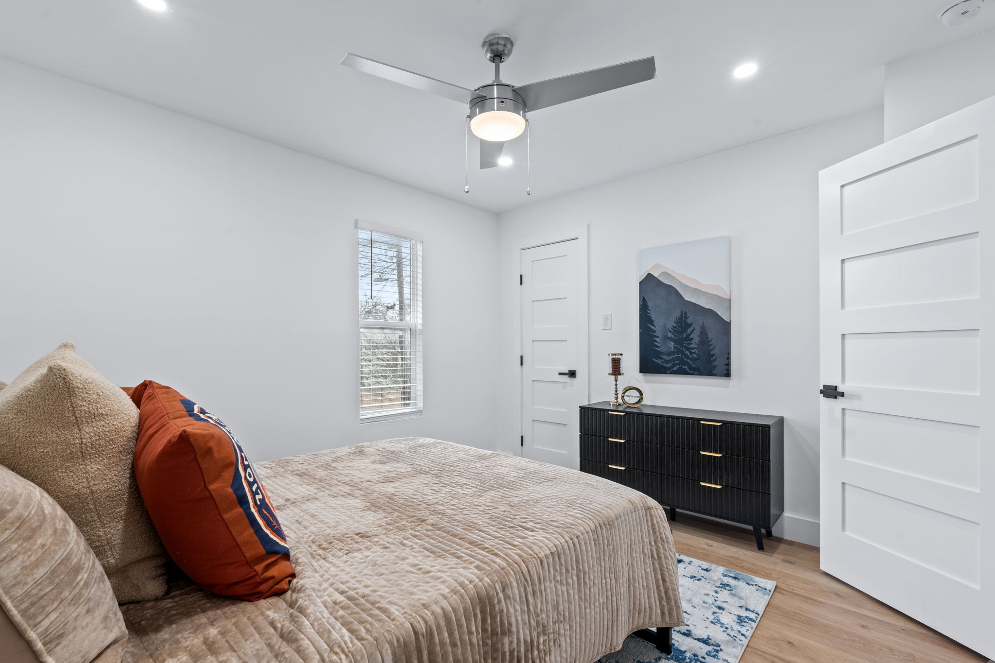 2706 Wheless Lane, Unit 101 Austin, TX 78723 - Photo 17 of 24 a bedroom with a bed and a flat screen tv