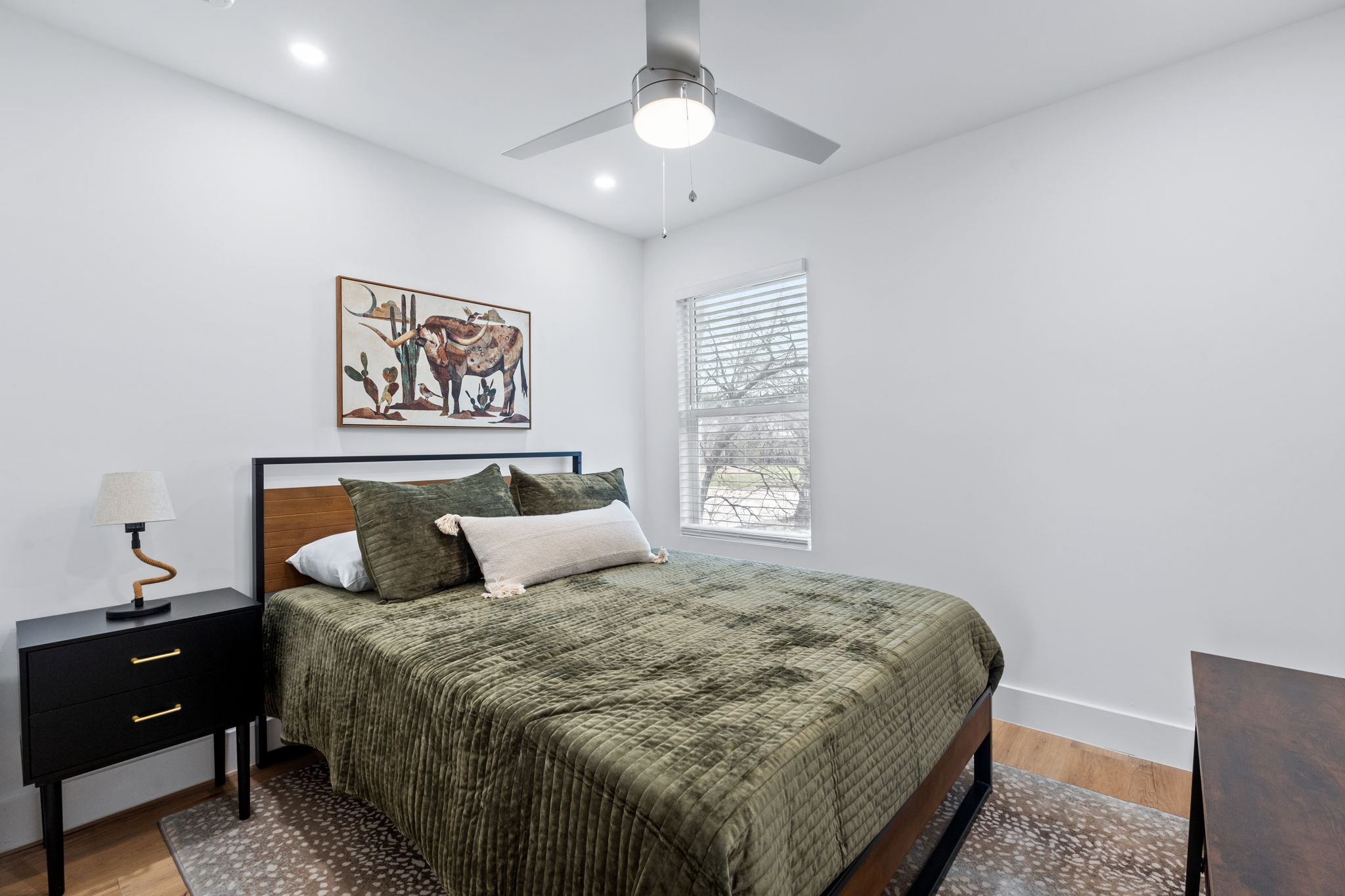 2706 Wheless Lane, Unit 101 Austin, TX 78723 - Photo 18 of 24 a bedroom with a bed and a chandelier