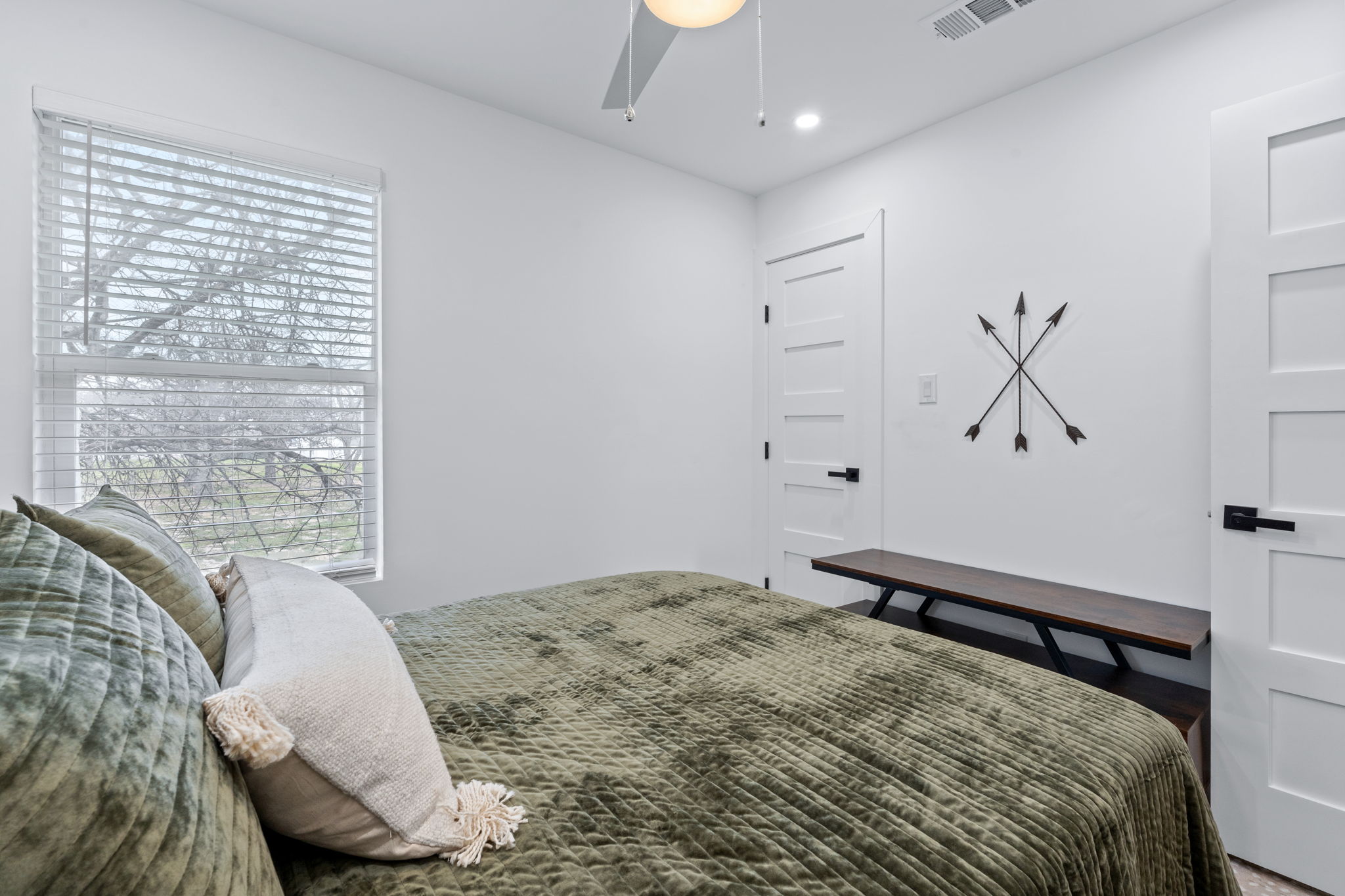 2706 Wheless Lane, Unit 101 Austin, TX 78723 - Photo 19 of 24 a bedroom with a large bed and a chandelier