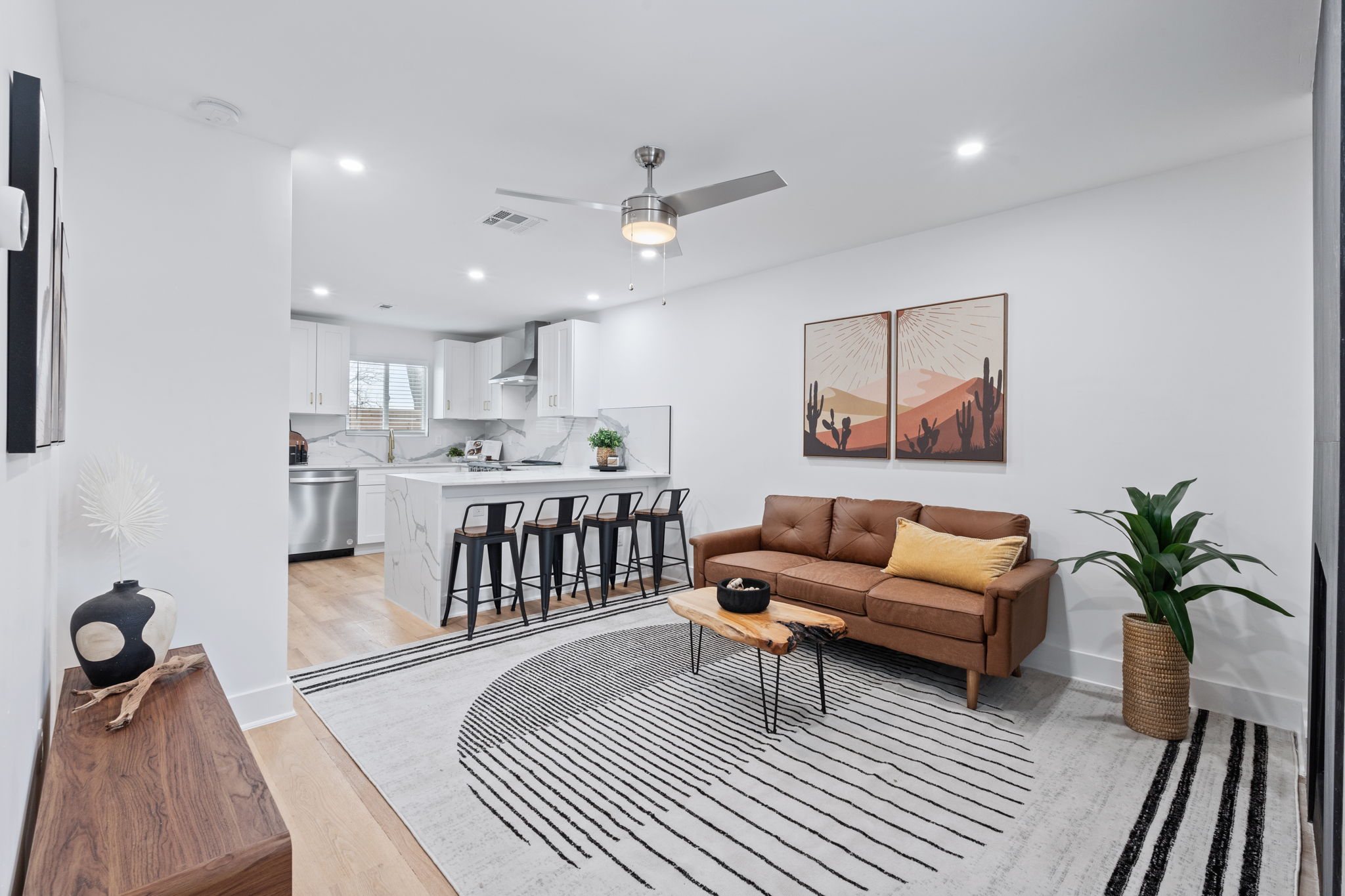 2706 Wheless Lane, Unit 101 Austin, TX 78723 - Photo 5 of 24 a living room with furniture a rug and a chandelier