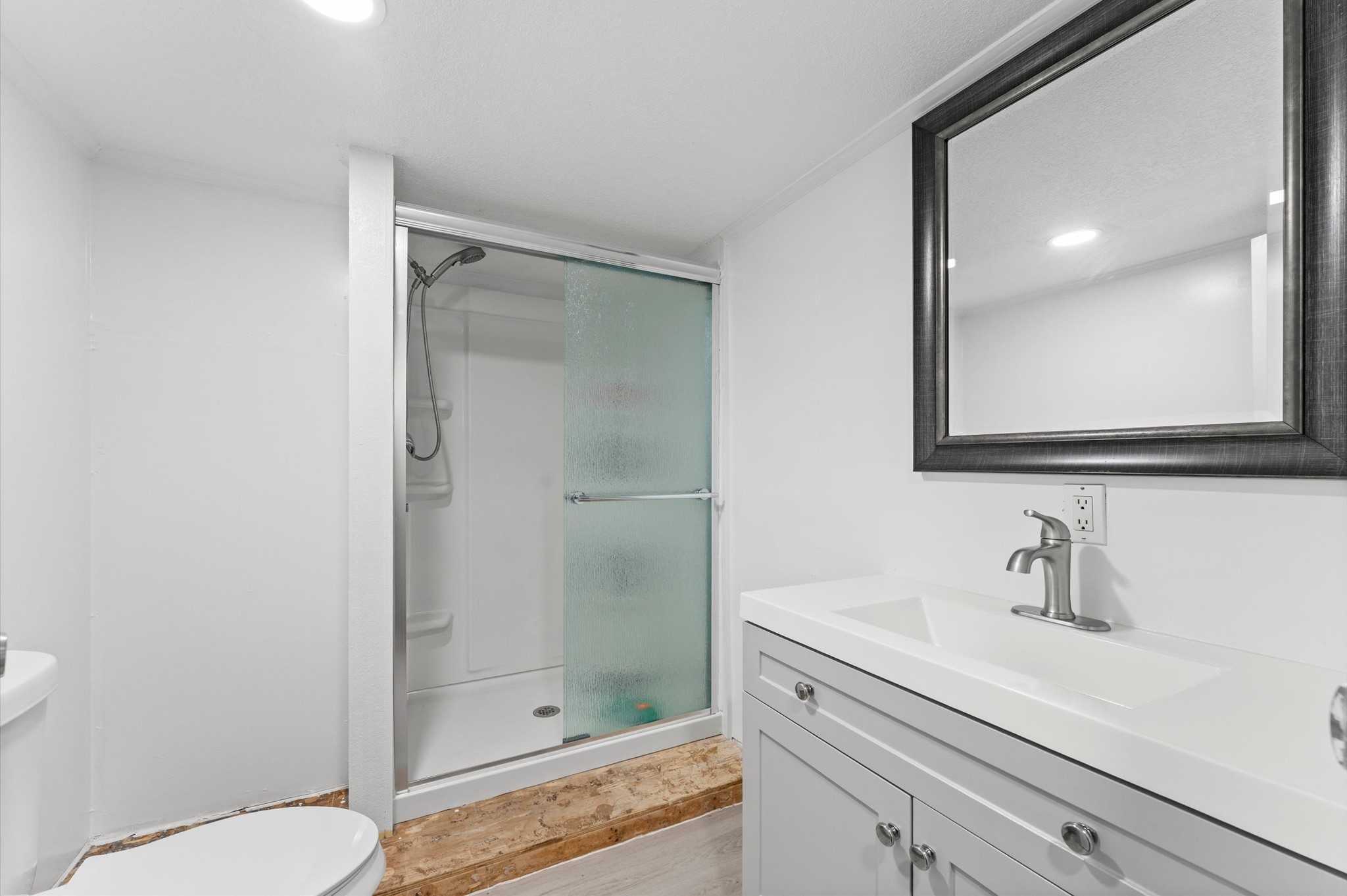 2504 Oak Ridge Road Willis, TX 77378 - Photo 5 of 10 a bathroom with a shower sink vanity mirror and toilet