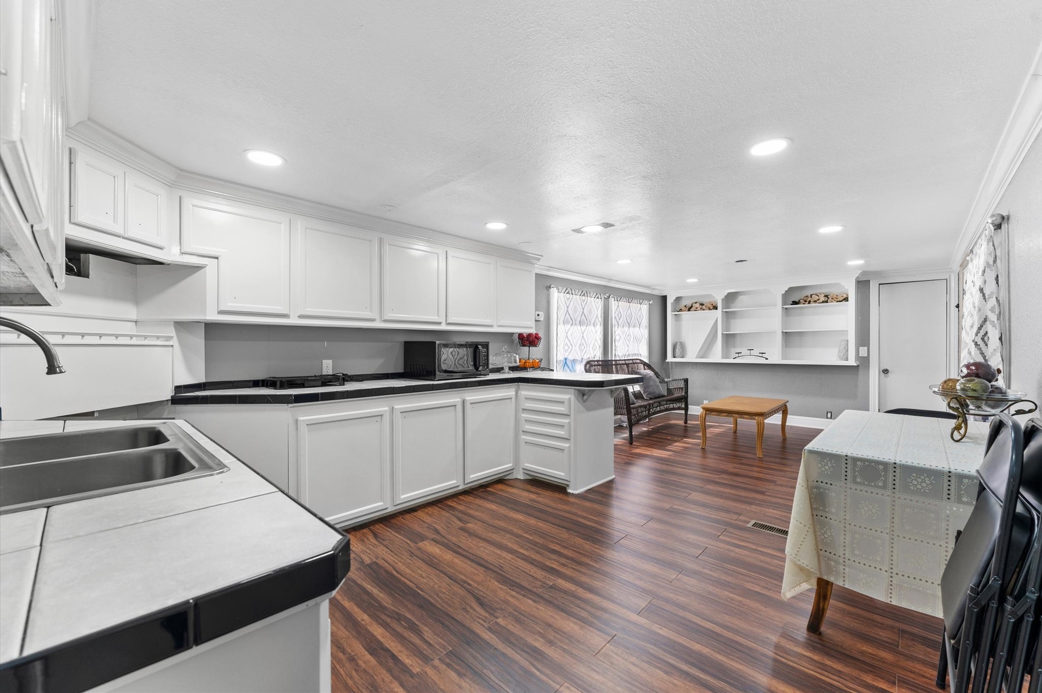 2504 Oak Ridge Road Willis, TX 77378 - Photo 6 of 10 a kitchen with stainless steel appliances granite countertop a refrigerator a stove top oven a sink dishwasher and white cabinets with wooden floor