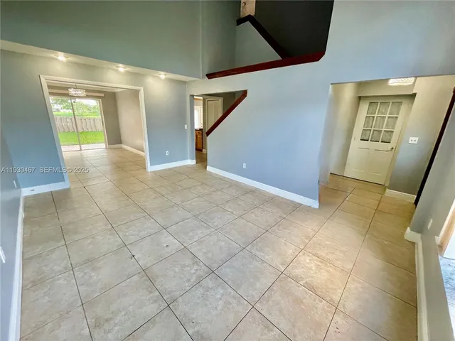 a view of an empty room and a bathroom