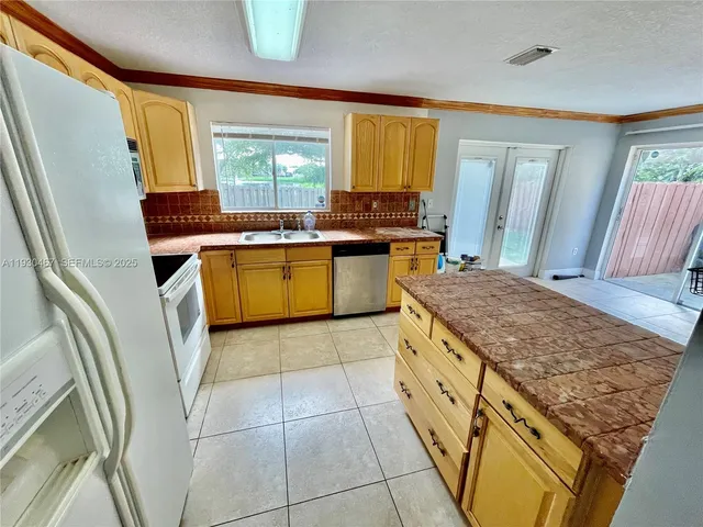 a kitchen with a sink a counter top space and cabinets