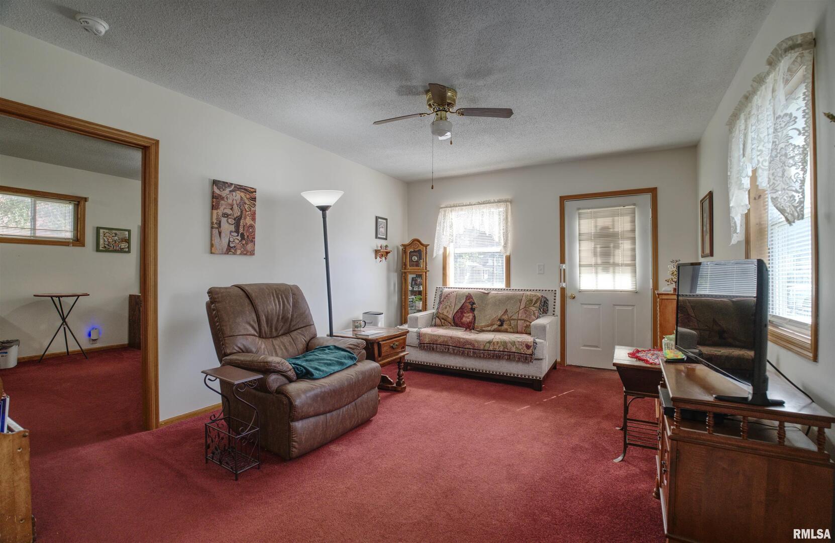 500 4th Avenue North Clinton, IA 52732 - Photo 9 of 18 a living room with furniture and a flat screen tv