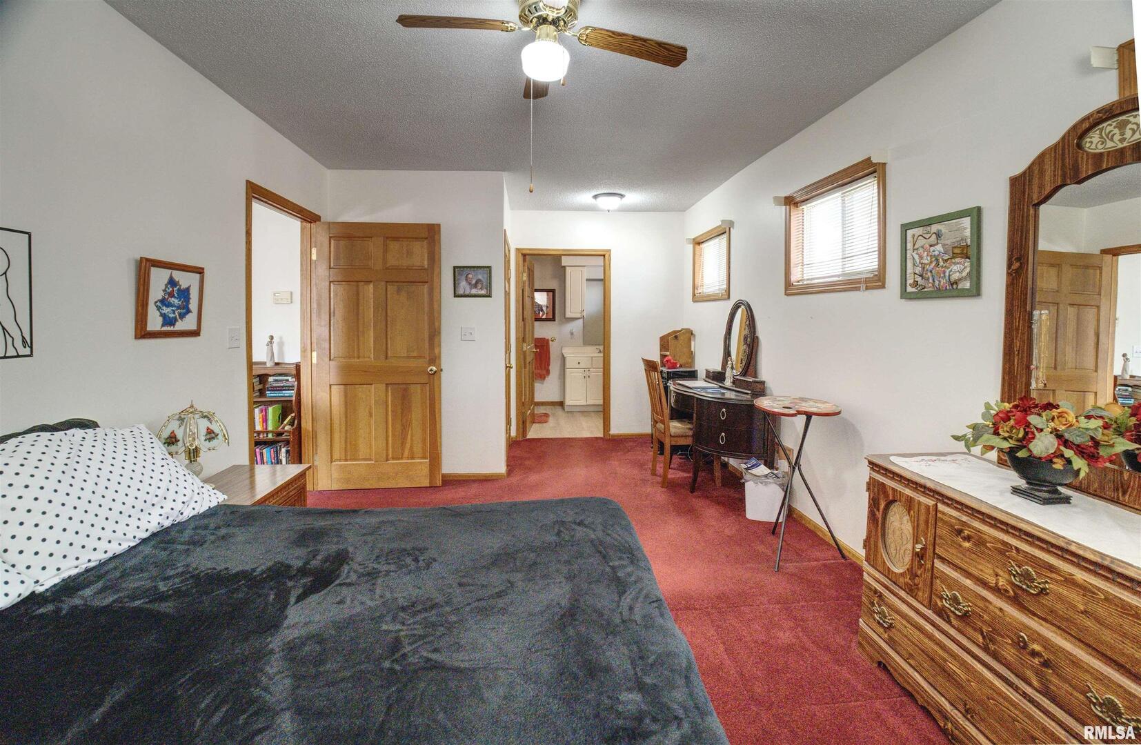 500 4th Avenue North Clinton, IA 52732 - Photo 10 of 18 a bedroom with furniture and a chandelier