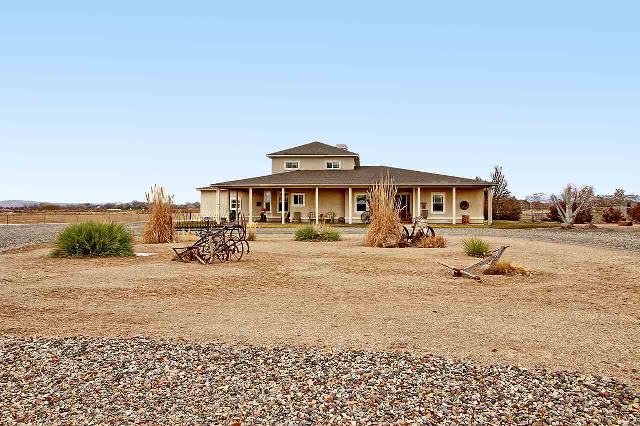 1871 High Point Court Fruita, CO 81521 - Photo 5 of 41 a front view of a house with a yard