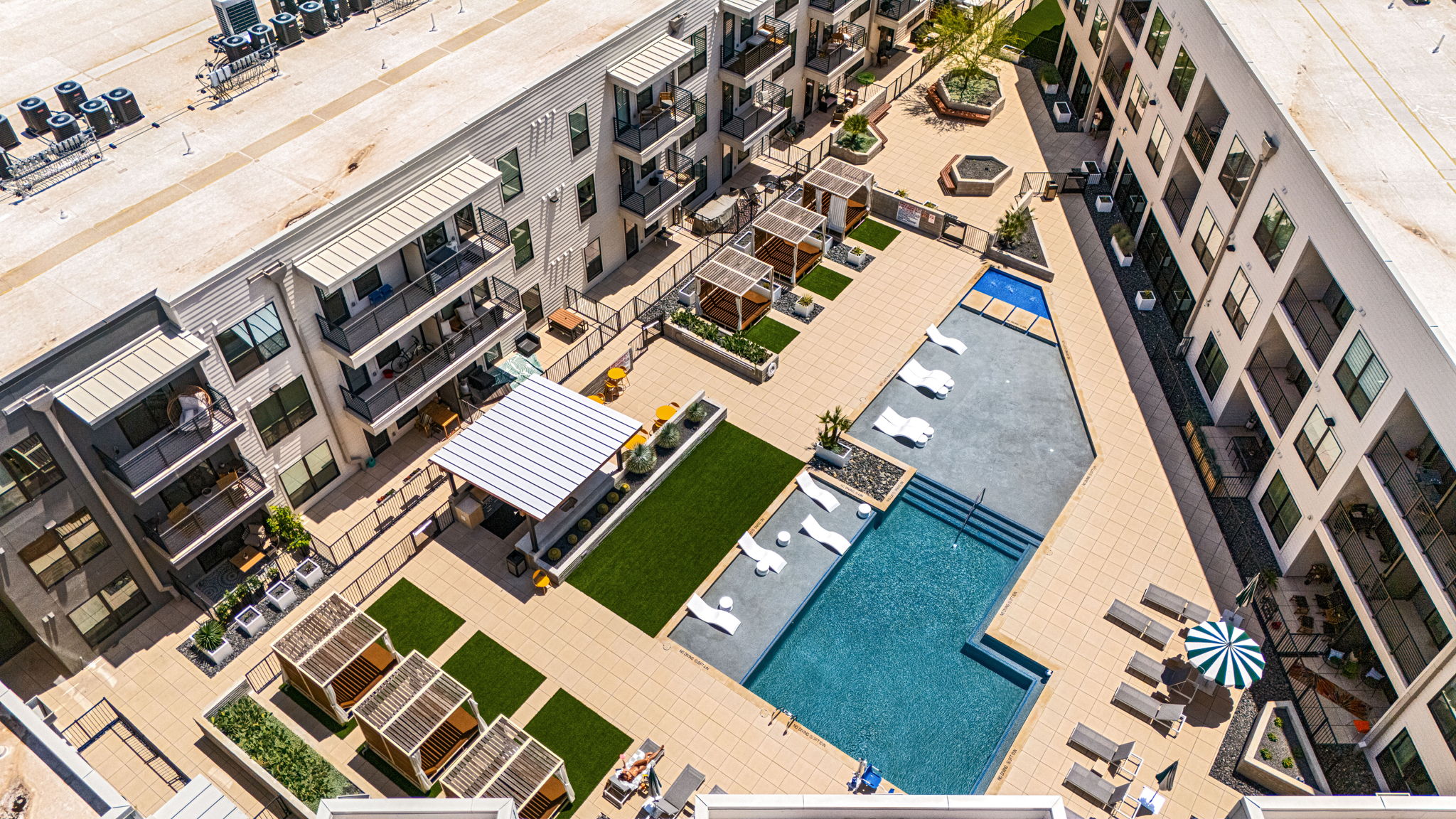 1701 Simond Avenue, Unit 612 Austin, TX 78723 - Photo 26 of 40 Modern courtyard featuring an irregular-shaped swimming pool with sun lounge areas and multiple cabanas