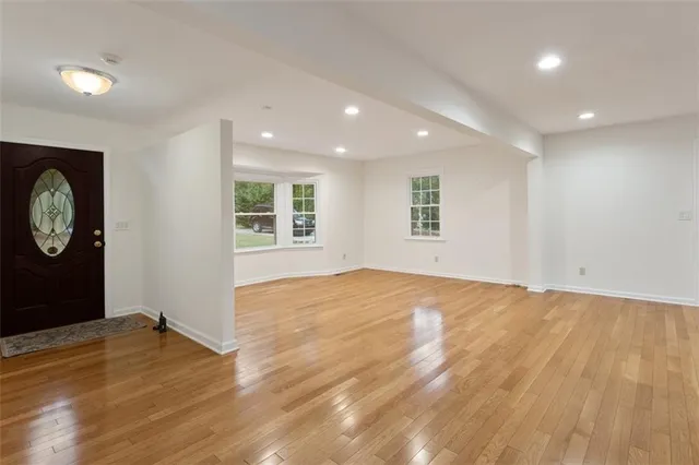 a bathroom with a granite countertop sink a toilet and a mirror