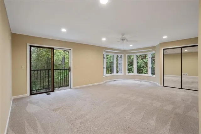 a bedroom with a large bed and a large window