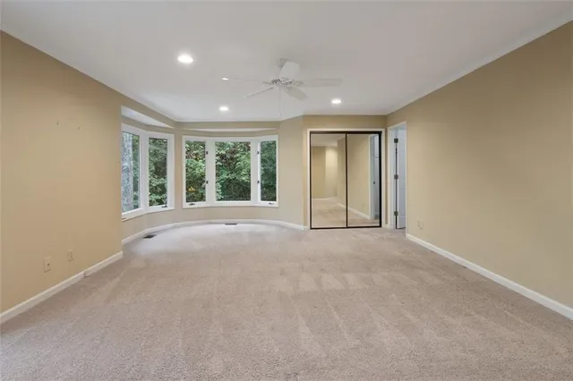a front view of a house with white fence