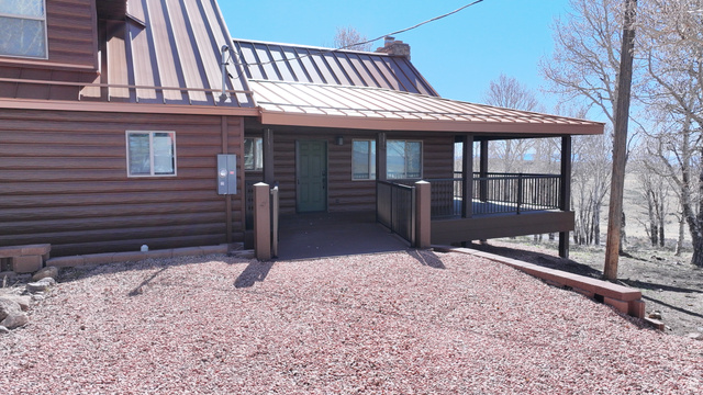 2031 South Quakie Road Koosharem, UT 84744 - Photo 5 of 33 Log-style exterior with a covered porch and metal roofing
