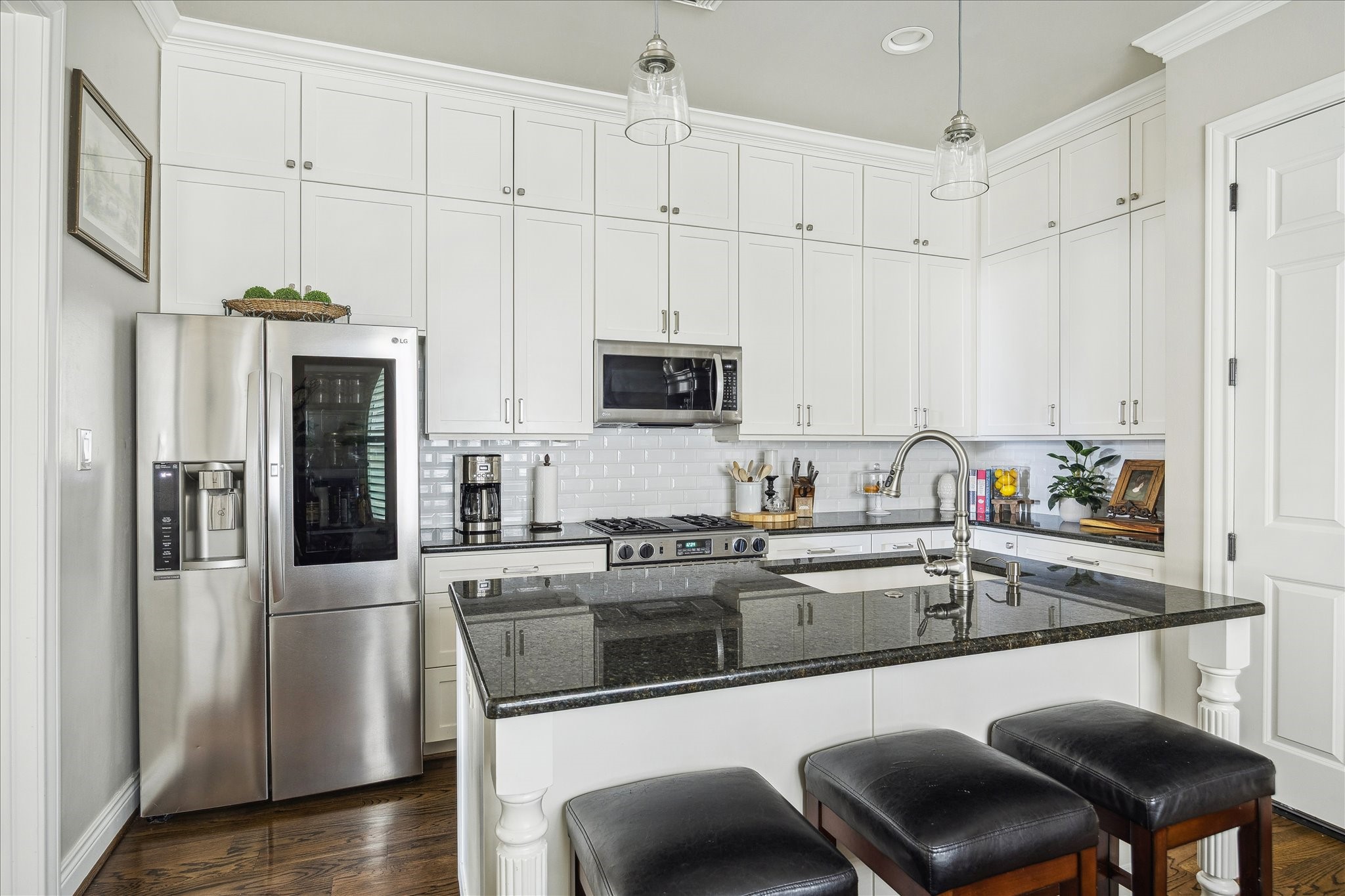 2435 North Boulevard Houston, TX 77098 - Photo 11 of 25 a kitchen with stainless steel appliances granite countertop a white cabinets and a granite counter tops