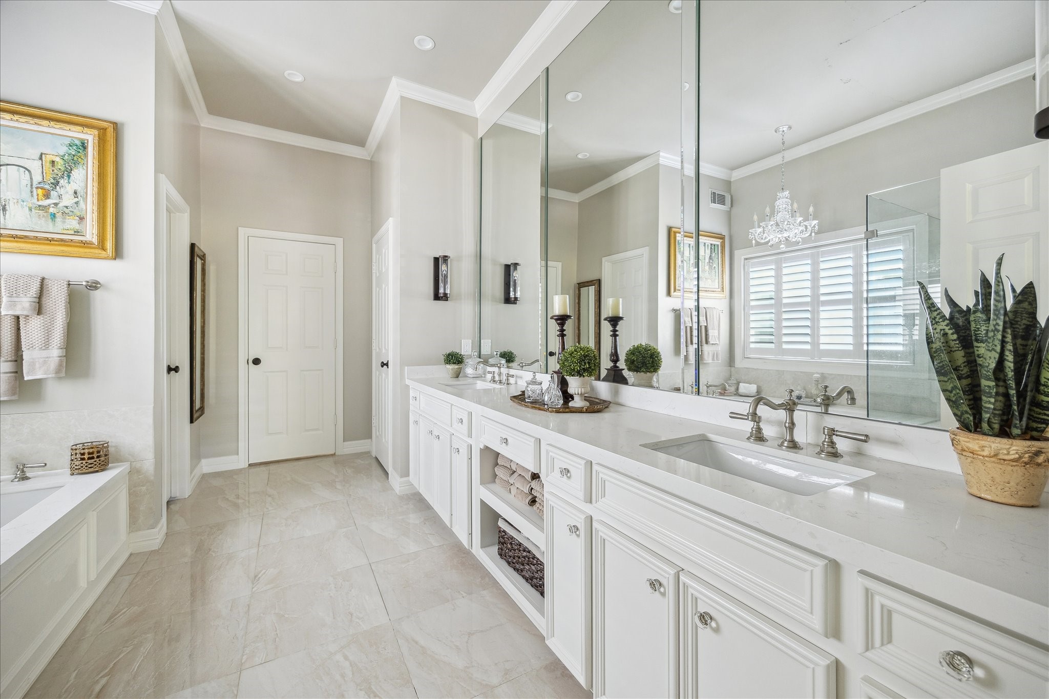 2435 North Boulevard Houston, TX 77098 - Photo 16 of 25 a spacious bathroom with a double vanity sink a mirror a potted plant and a bathtub
