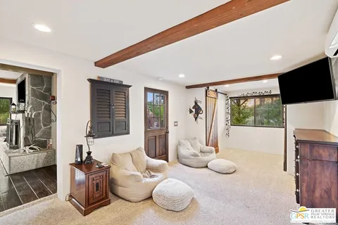 a view of an empty room with furniture and a window