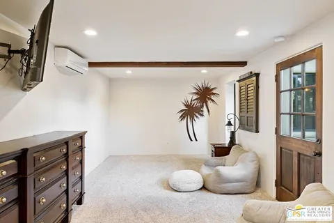 an empty room with floor to ceiling windows and a flat screen tv