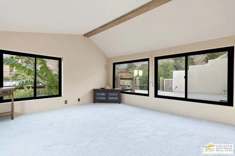 a view of a patio with two chairs and a table