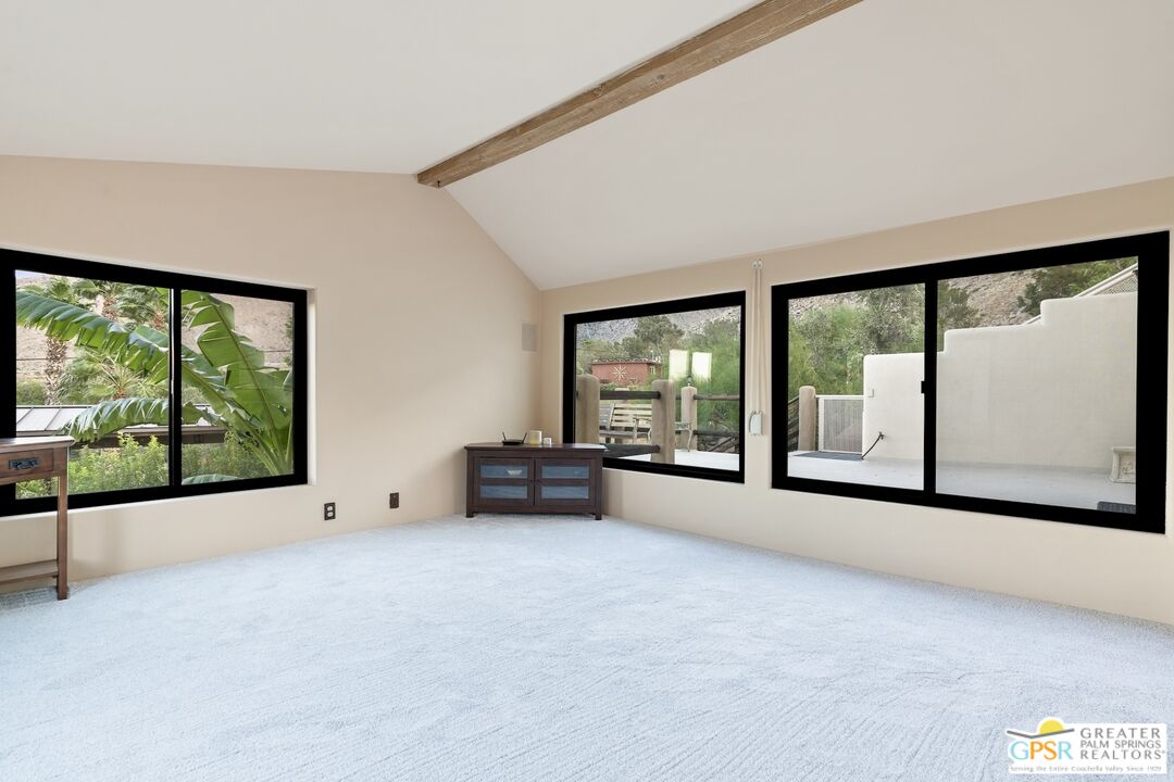 15911 Falls Creek Road Whitewater, CA 92282 - Photo 18 of 61 an empty room with floor to ceiling windows and a flat screen tv