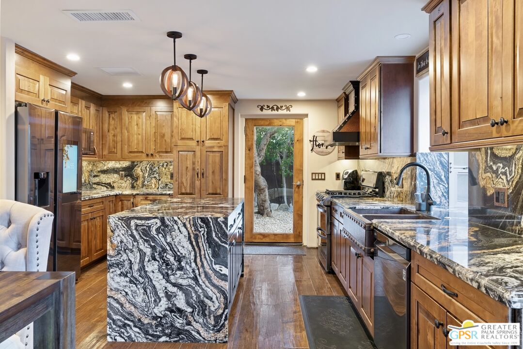 15911 Falls Creek Road Whitewater, CA 92282 - Photo 22 of 61 a kitchen with stainless steel appliances granite countertop a sink stove and refrigerator