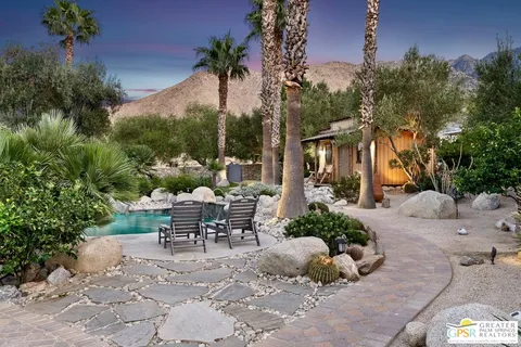 a view of a chair and table in the backyard