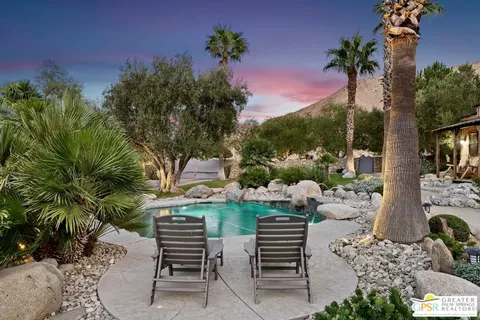 a view of a patio with two chairs and a table