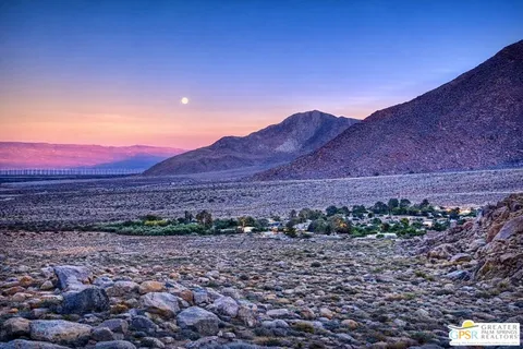 an aerial view of a house with yard and swimming pool