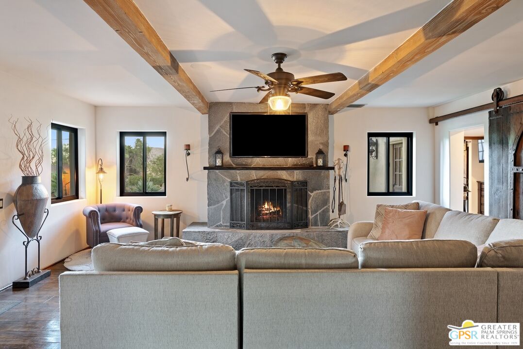 15911 Falls Creek Road Whitewater, CA 92282 - Photo 8 of 61 a living room with furniture a flat screen tv and a fireplace