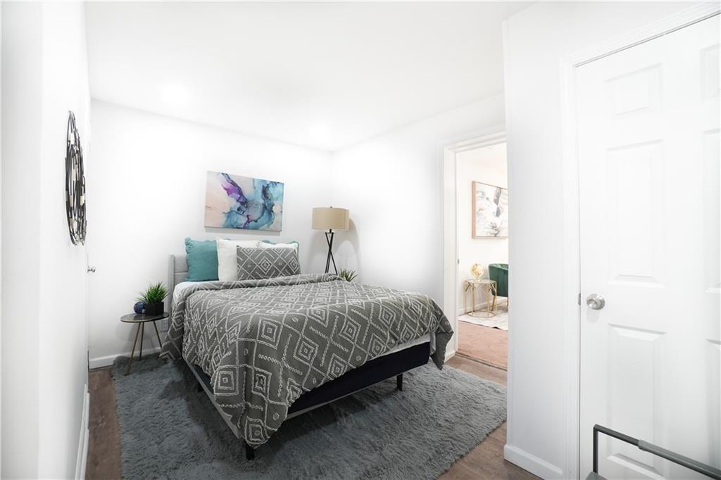 444 Fairburn Road Northwest Atlanta, GA 30331 - Photo 13 of 21 a spacious bedroom with a bed and a wall painting