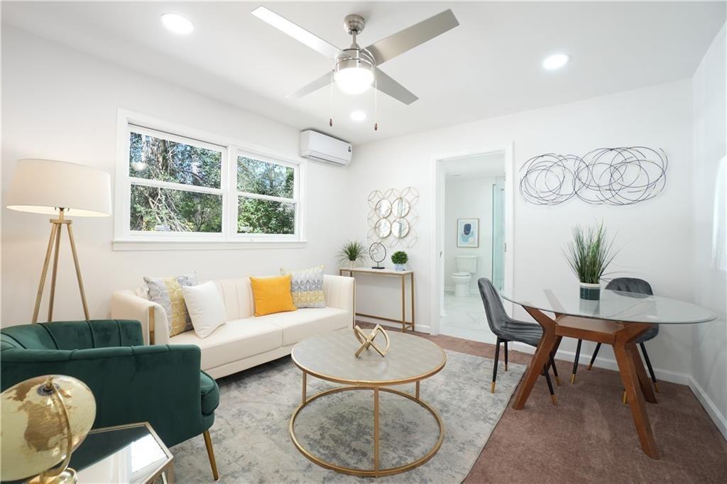 444 Fairburn Road Northwest Atlanta, GA 30331 - Photo 15 of 21 a living room with furniture a table and a large window