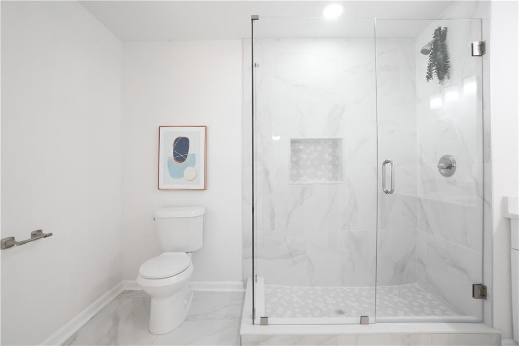 444 Fairburn Road Northwest Atlanta, GA 30331 - Photo 17 of 21 a bathroom with a shower and a toilet
