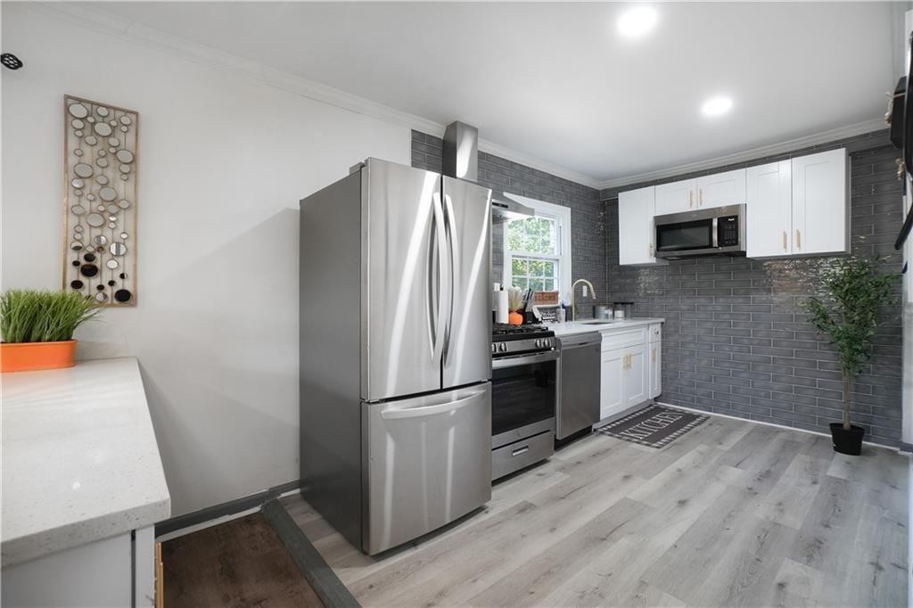 444 Fairburn Road Northwest Atlanta, GA 30331 - Photo 5 of 21 a kitchen with a refrigerator sink and microwave