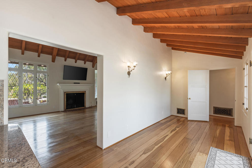 369 West Kenneth Road Glendale, CA 91202 - Photo 12 of 36 a view of empty room with wooden floor and fireplace