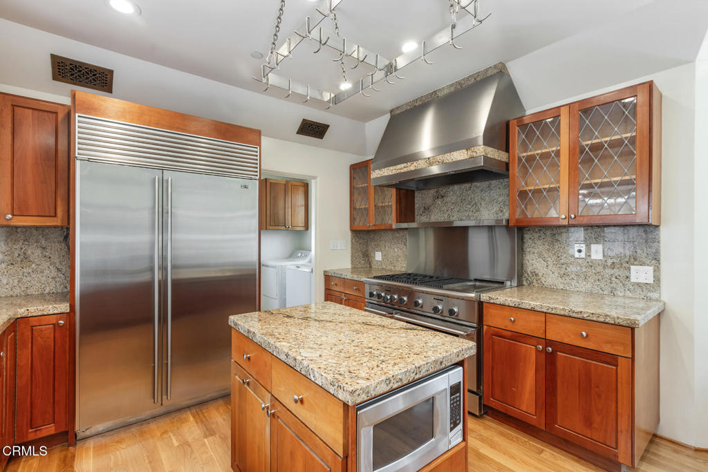 369 West Kenneth Road Glendale, CA 91202 - Photo 17 of 36 a kitchen with stainless steel appliances granite countertop a stove and a refrigerator