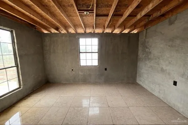 a view of an empty room with a window