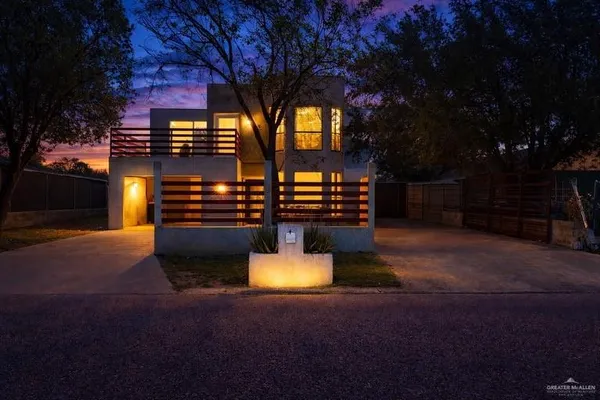 a front view of a house with a yard fire pit and outdoor seating