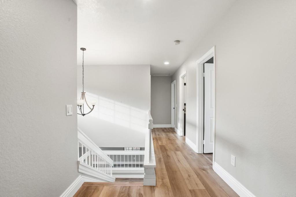 391 Via Almansa Encinitas, CA 92024 - Photo 27 of 35 a view of a room with wooden floor and a ceiling fan