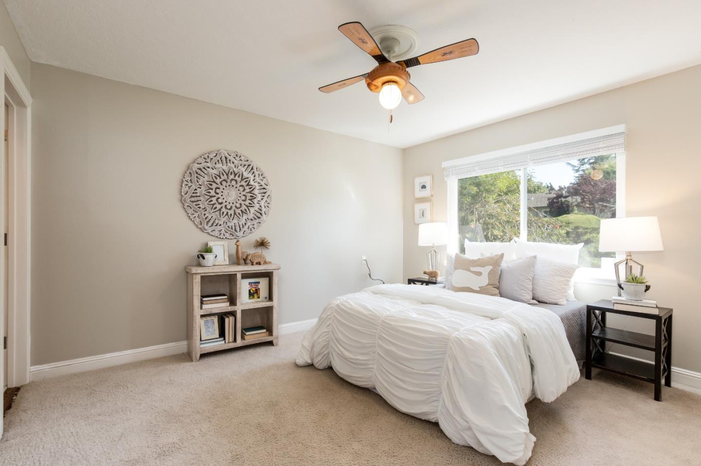 356 Barbara Way Hillsborough, CA 94010 - Photo 14 of 37 a bedroom with a bed and a chandelier