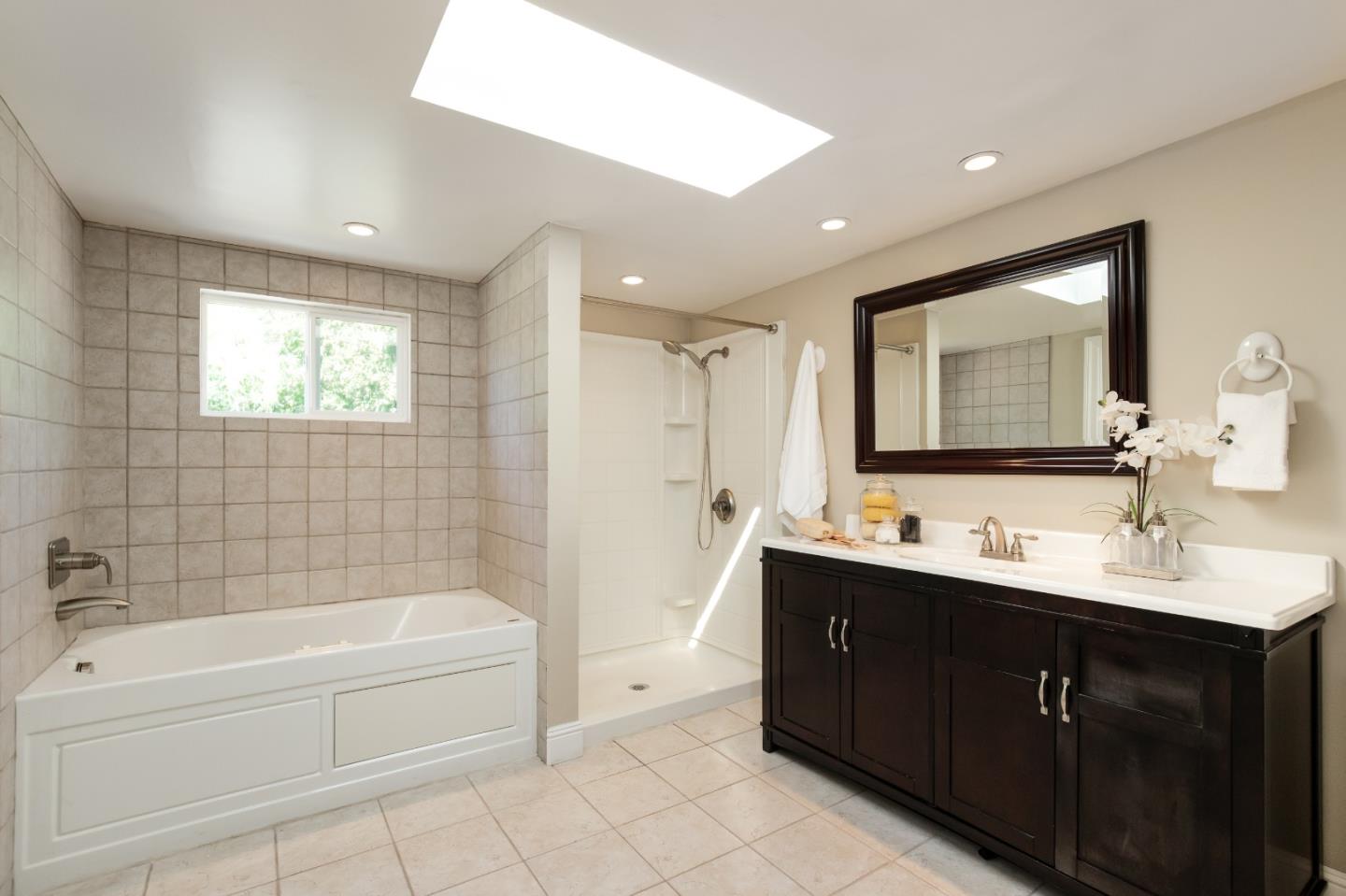 356 Barbara Way Hillsborough, CA 94010 - Photo 18 of 37 a bathroom with a tub sink double vanity granite tub shower and a mirror