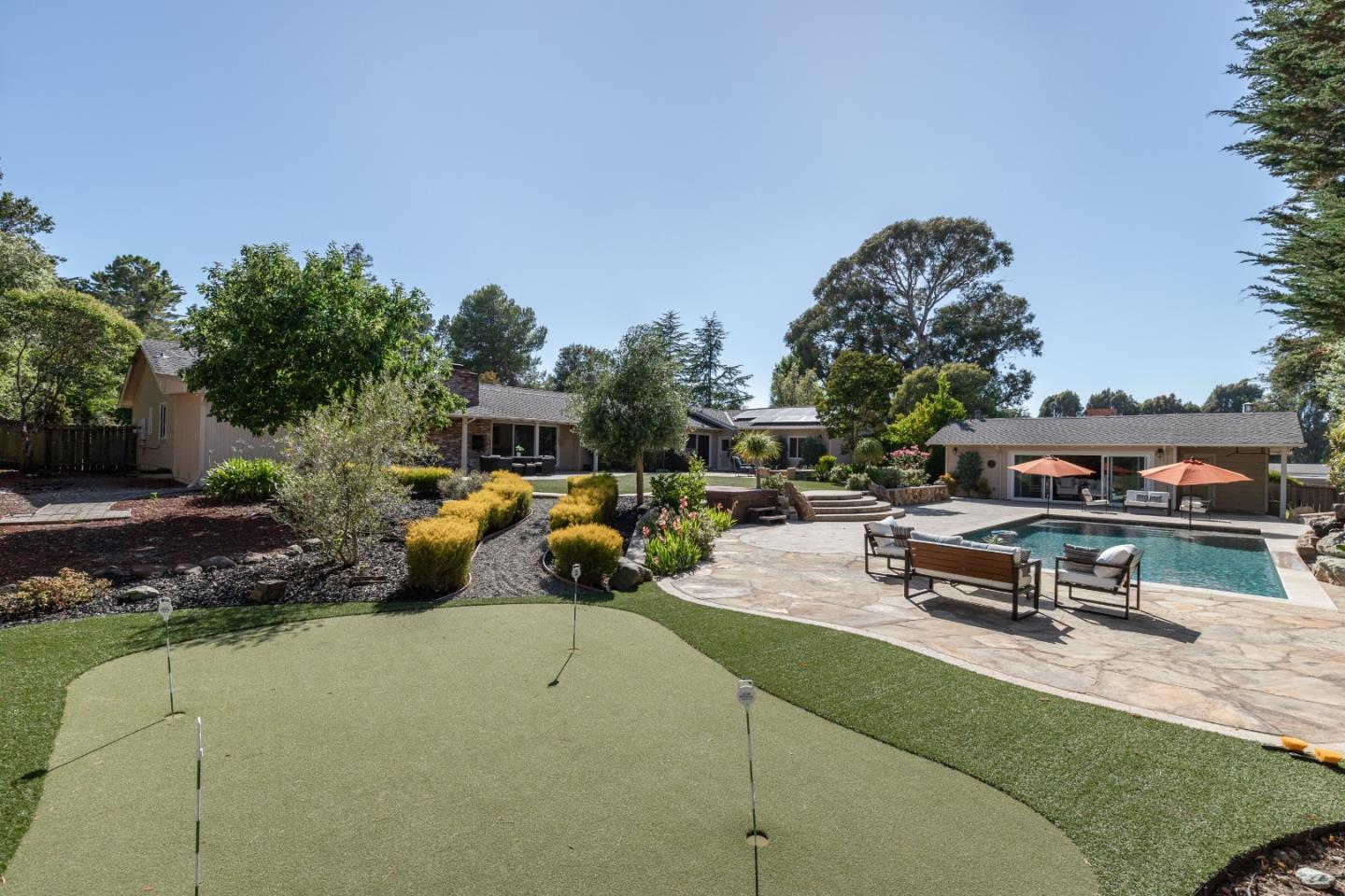 356 Barbara Way Hillsborough, CA 94010 - Photo 34 of 37 a swimming pool with outdoor seating and trees