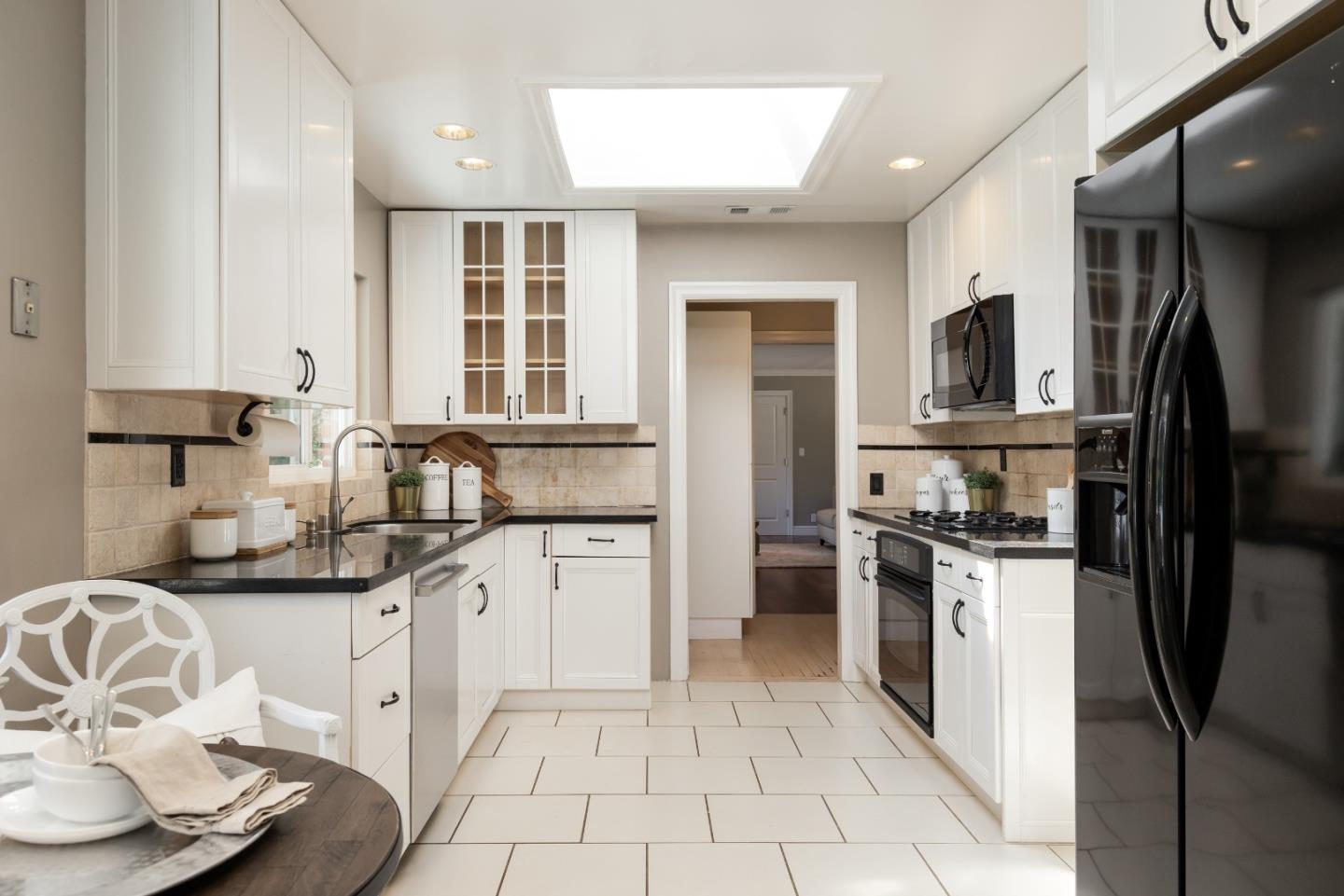 356 Barbara Way Hillsborough, CA 94010 - Photo 7 of 37 a kitchen with stainless steel appliances granite countertop a refrigerator sink and stove