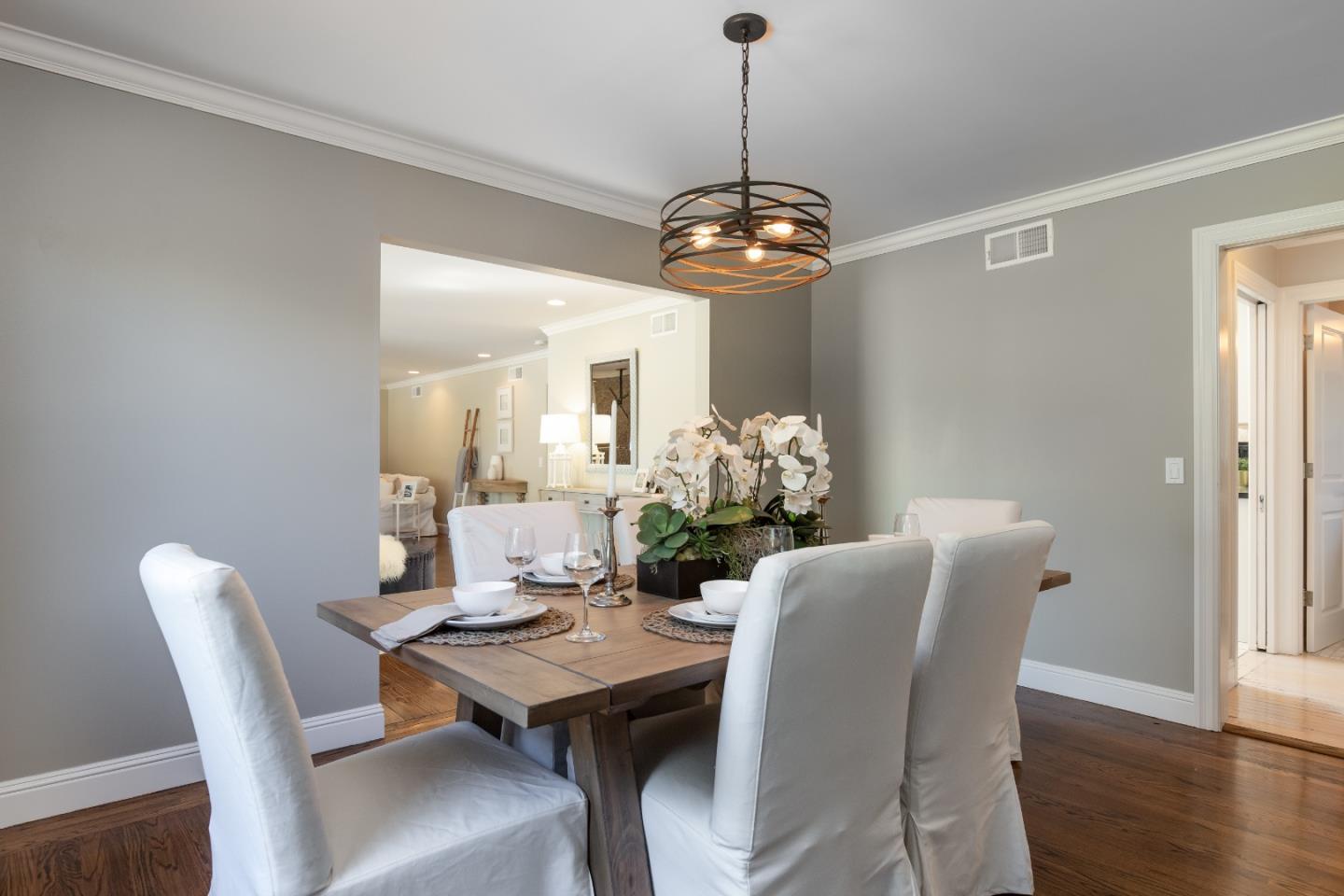356 Barbara Way Hillsborough, CA 94010 - Photo 10 of 37 a view of a dining room with furniture a chandelier and wooden floor